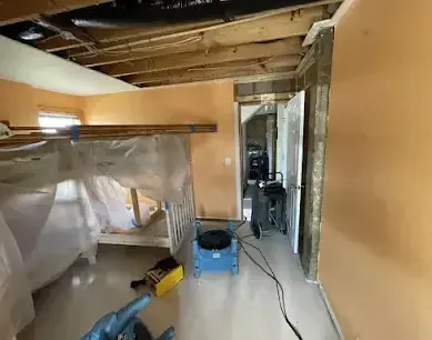 Containment plastic and drying equipment set up under an opened ceiling